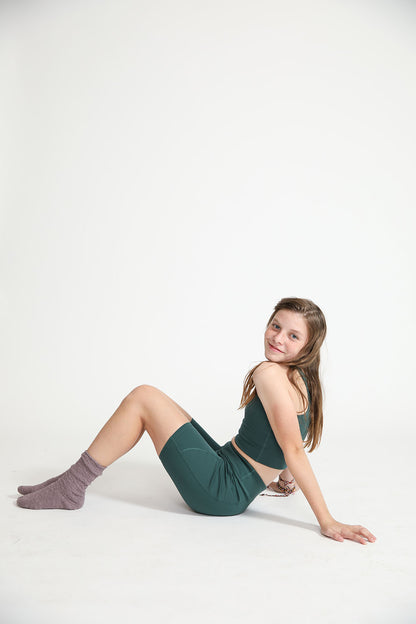 Young girl wearing Everyway kids activewear. Featuring Long Line Crop in Pine.