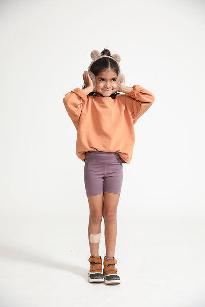 Young girl wearing Everyway kids activewear. Featuring Cycle Shorts in Plum.