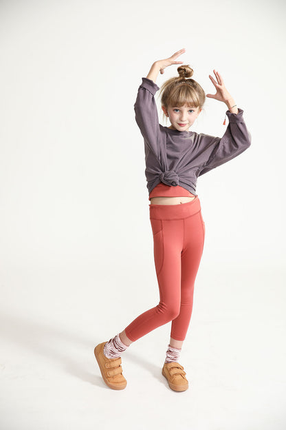 Young girl wearing Everyway kids activewear. Featuring Spice Longline Crop and All Day Leggings.