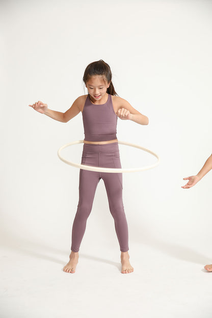 Young girl wearing Everyway kids activewear. Featuring Long Line Crop in Plum.