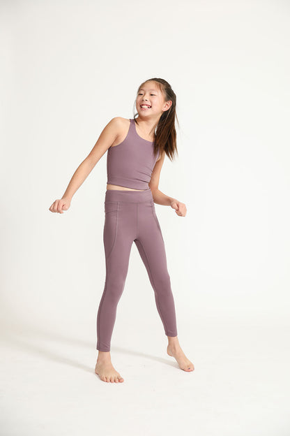 Young girl wearing Everyway kids activewear. Featuring Long Line Crop in Plum.