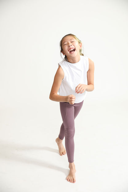 Young girl wearing Everyway kids activewear. Featuring Daily Tank Top in White.