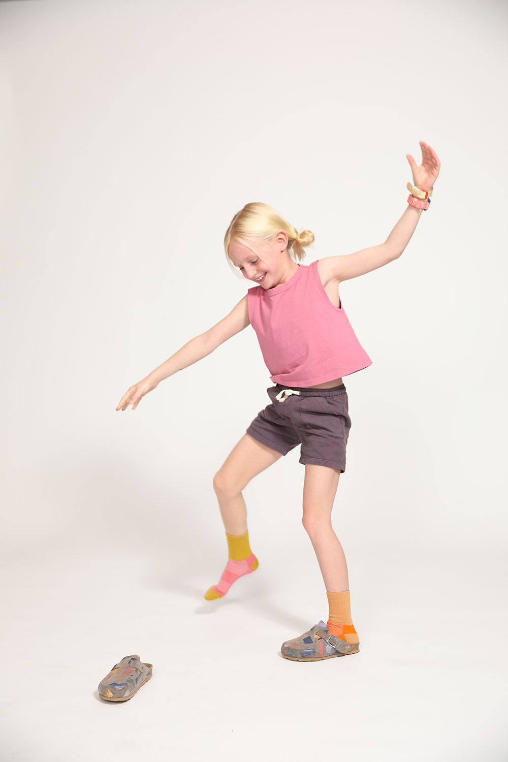 Young girl wearing Everyway kids activewear. Featuring Core Sweat Shorts in Plum.