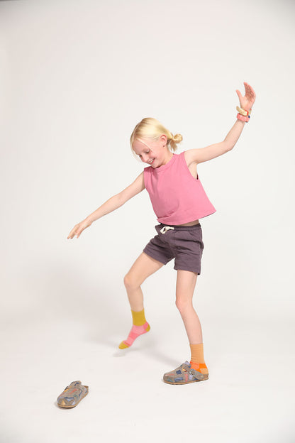 Young girl wearing Everyway kids activewear. Featuring Daily Tank Top in Dusty Rose.