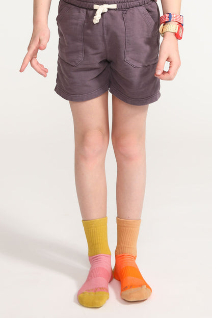 A young girl wearing crew socks from Everyway kids activewear.