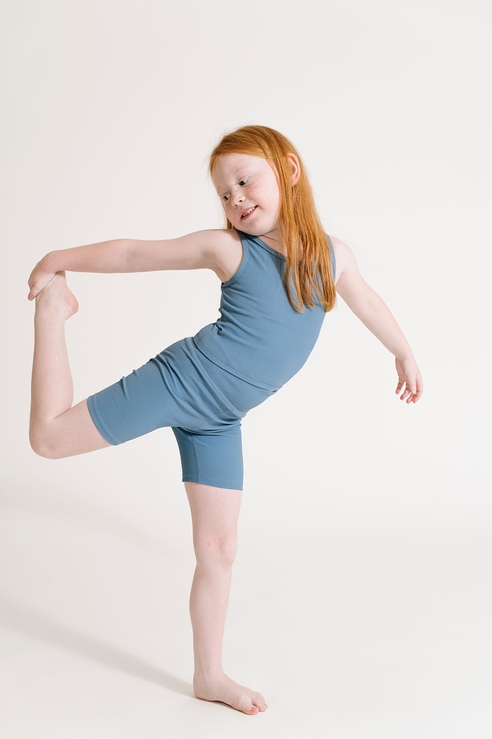 Young girl wearing Everyway kids activewear. Featuring Ribbed Cycle Shorts in Cornflower.