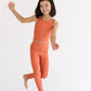 Young girl wearing Everyway kids activewear. Featuring Sporty Ribbed Leggings in Persimmon.