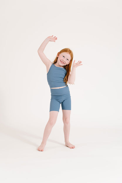 Young girl wearing Everyway kids activewear. Featuring Ribbed Cycle Shorts in Cornflower.