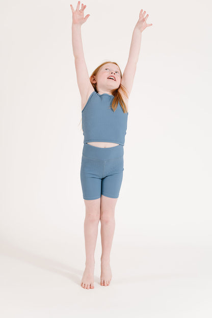 Young girl wearing Everyway kids activewear. Featuring Ribbed Cycle Shorts in Cornflower.