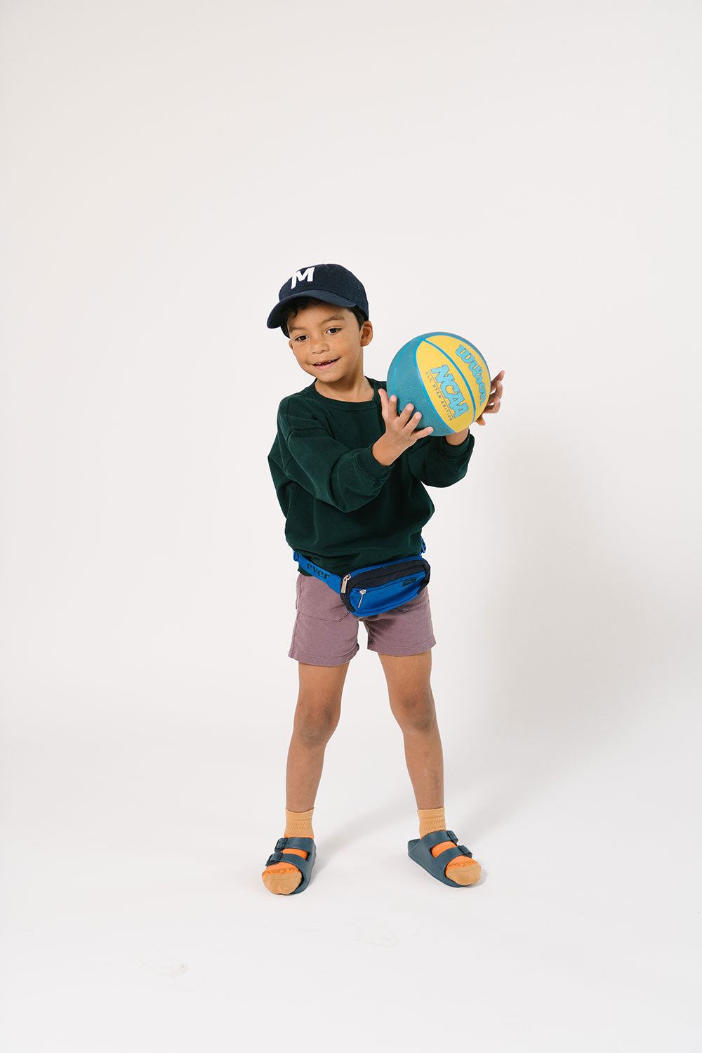 Young boy playing with a basketball in Everyway activewear. Featuring fanny pack in blue