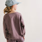 Young girl wearing Everyway kids activewear. Featuring Cloud Shorts in Plum.