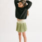Young girl wearing Everyway kids activewear. Featuring Pleated Court Skort in Lime.