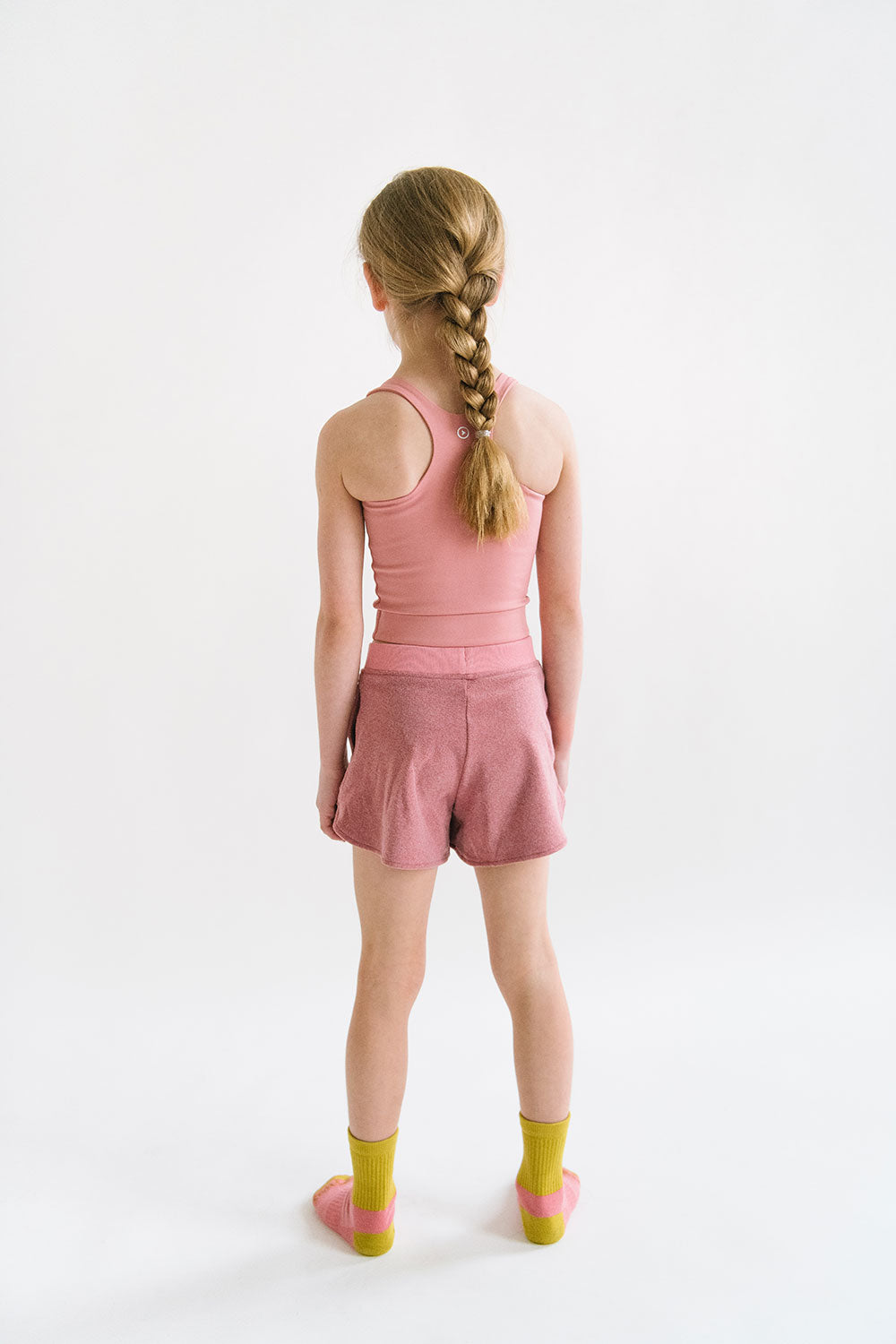 Young girl wearing Everyway kids activewear. Featuring Cloud Shorts in Berry.
