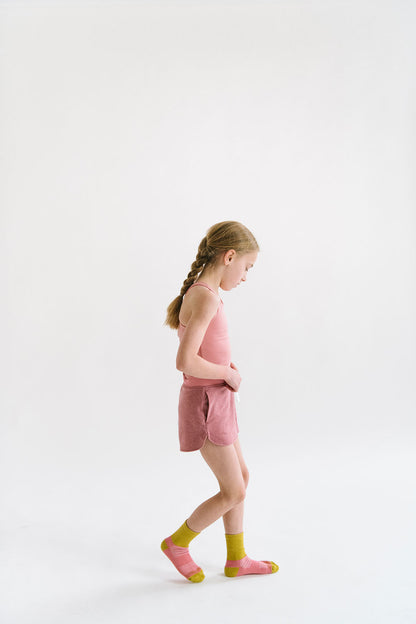 Young girl wearing Everyway kids activewear. Featuring Cloud Shorts in Berry.