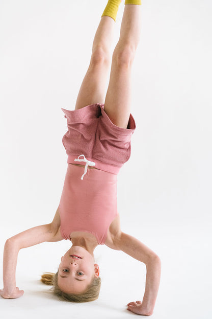 Young girl wearing Everyway kids activewear. Featuring Cloud Shorts in Berry.