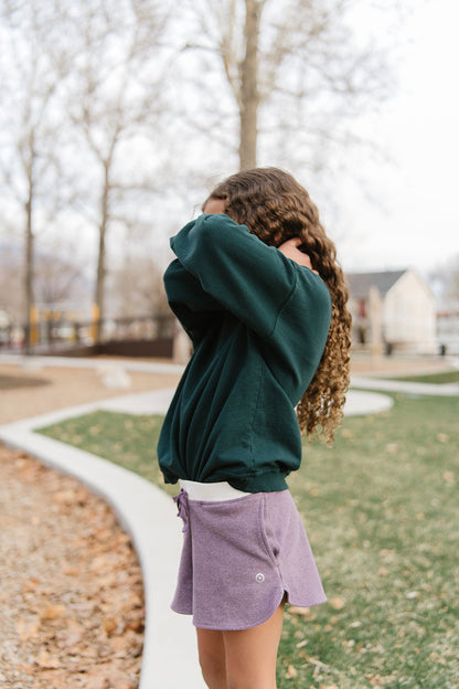 Young girl wearing Everyway kids activewear. Featuring Cloud Shorts in Plum.