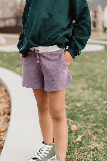 Young girl wearing Everyway kids activewear. Featuring Cloud Shorts in Plum.