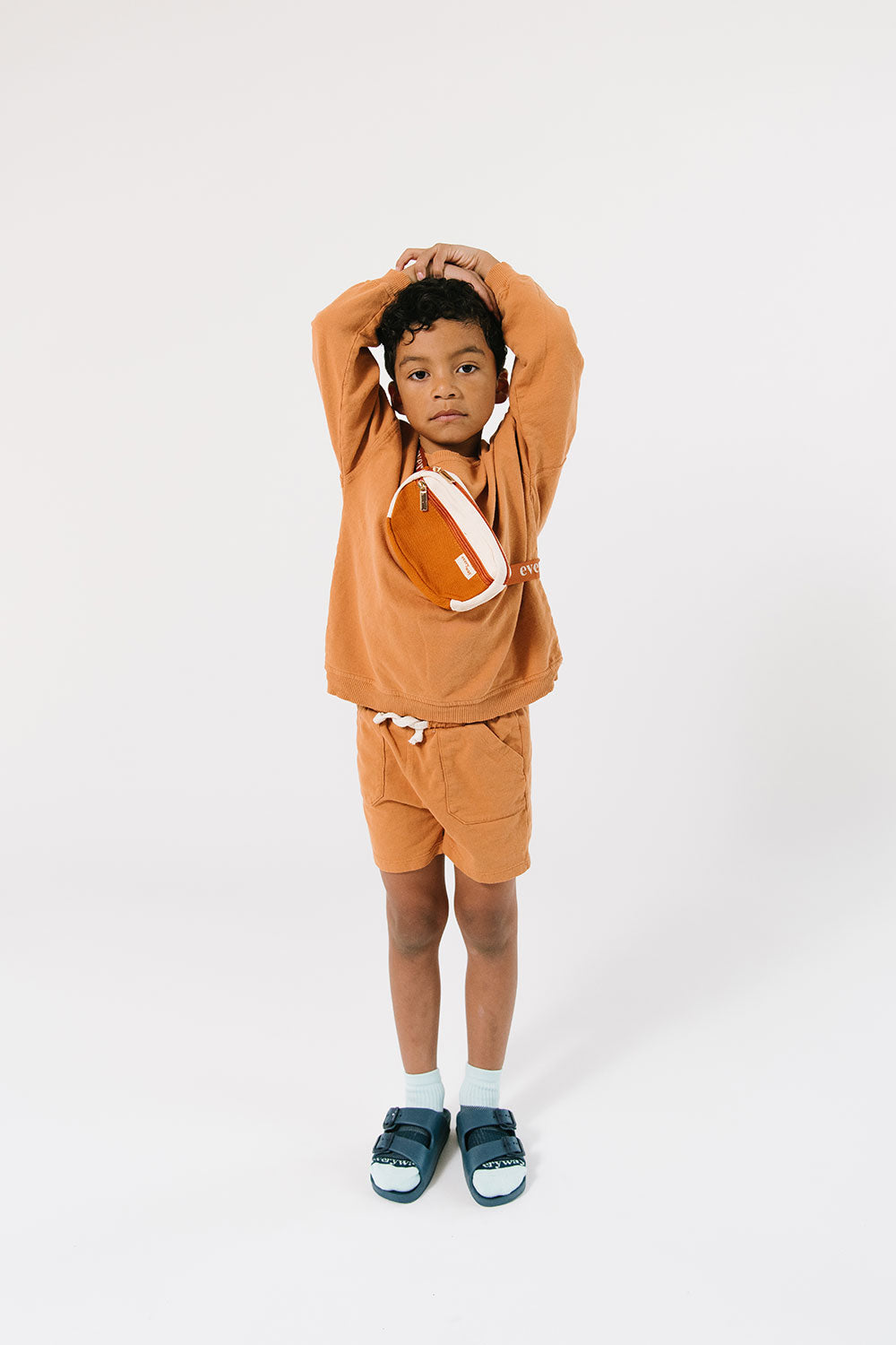 Young boy wearing Everyway kids activewear. Featuring Fanny Pack in Rust.