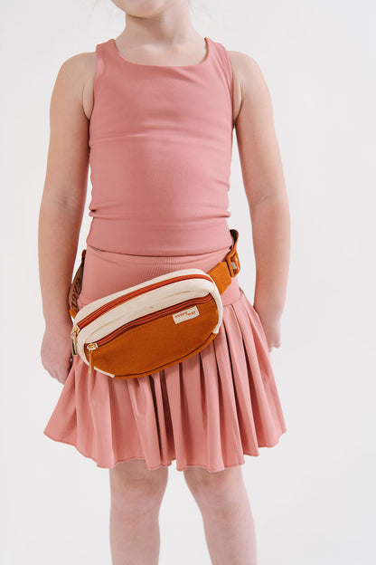 Young girl wearing Everyway kids activewear. Featuring Pleated Court Skort in Rose.