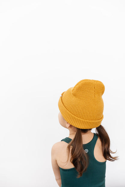 Young girl wearing Everyway kids activewear. Featuring Waffle Knit Beanie in Honey.