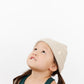 Young girl wearing Everyway kids activewear. Featuring Waffle Knit Beanie in Cream.