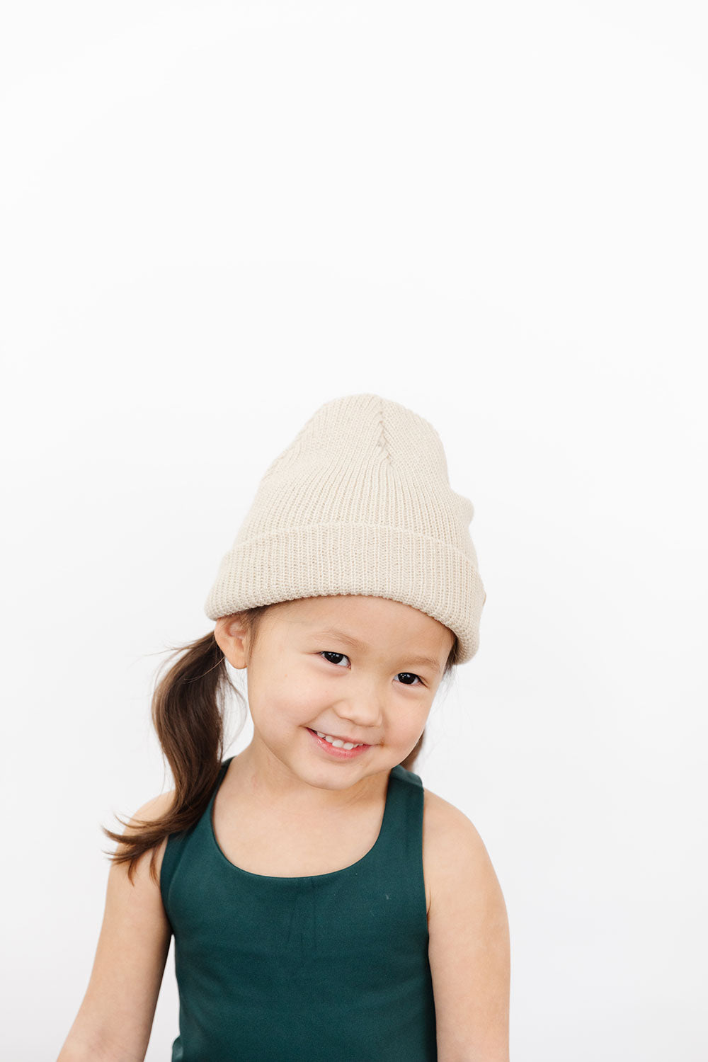 Young girl wearing Everyway kids activewear. Featuring Waffle Knit Beanie in Cream.